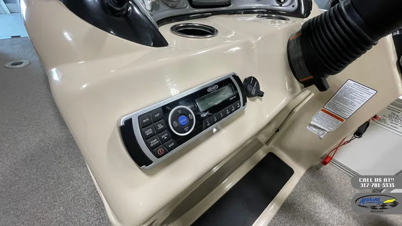 Slide: The Image of 2016 Sun Tracker Party Barge 22 DLX dashboard with stereo system and controls. - 15