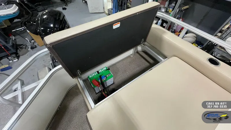 Slide: The Image of 2016 Sun Tracker Party Barge 22 DLX with open seat storage revealing battery compartment. - 5