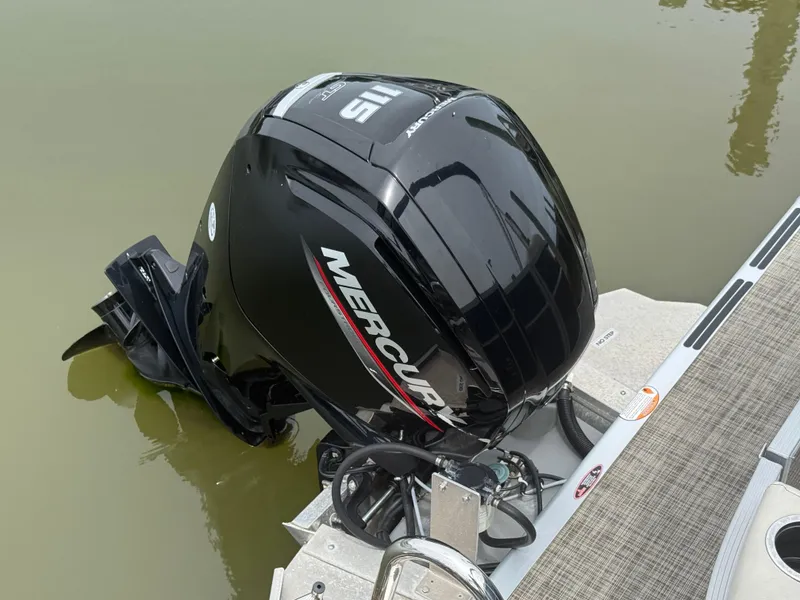 Slide: The Image of 2023 Cypress Cay Seabreeze 232 with Mercury outboard motor on calm water. - 4