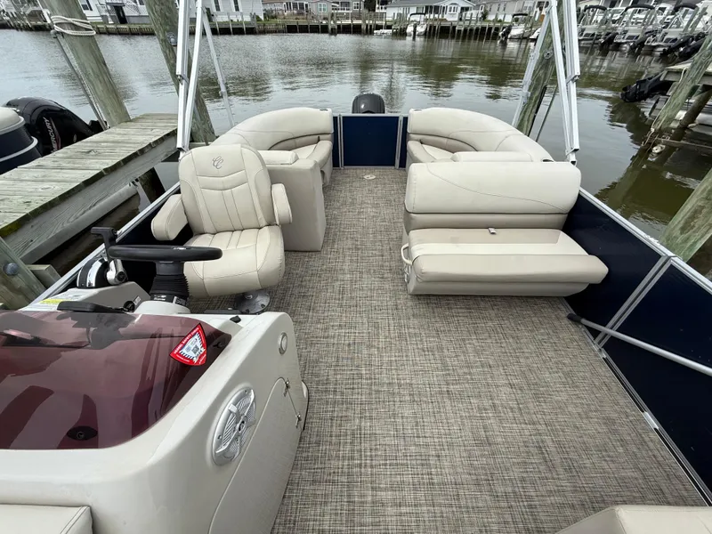 Slide: The Image of 2023 Cypress Cay Seabreeze 232 pontoon boat interior with beige seating and helm. - 6
