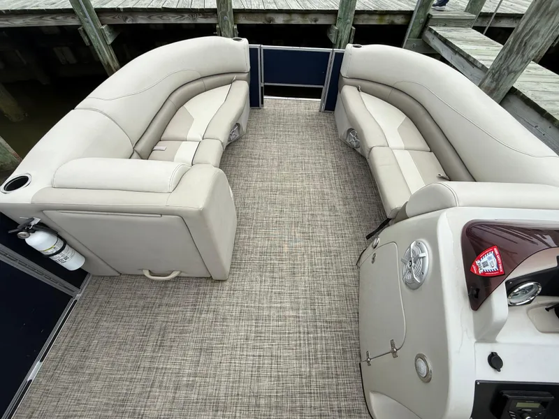 Slide: The Image of 2023 Cypress Cay Seabreeze 232 pontoon boat interior with beige seating and carpeted floor. - 7