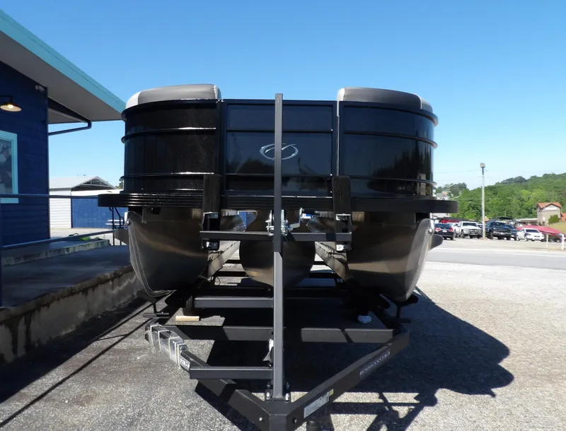 Slide: The Image of 2025 Veranda Relax 22 RC pontoon boat on trailer, parked outdoors. - 10