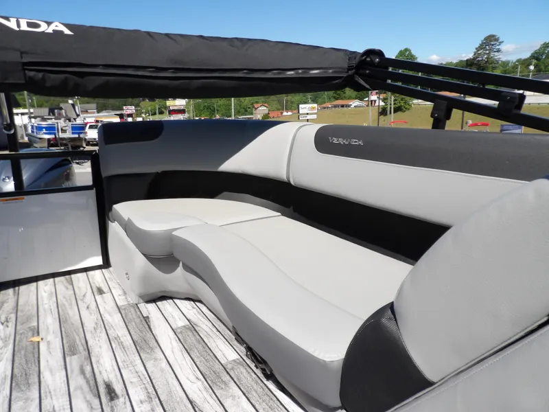 Slide: The Image of 2025 Veranda Relax 22 RC boat interior with sleek seating and canopy. - 13
