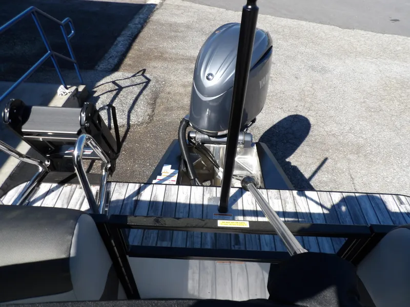 Slide: The Image of 2025 Veranda Relax 22 RC boat with Yamaha outboard motor, docked on a sunny day. - 14