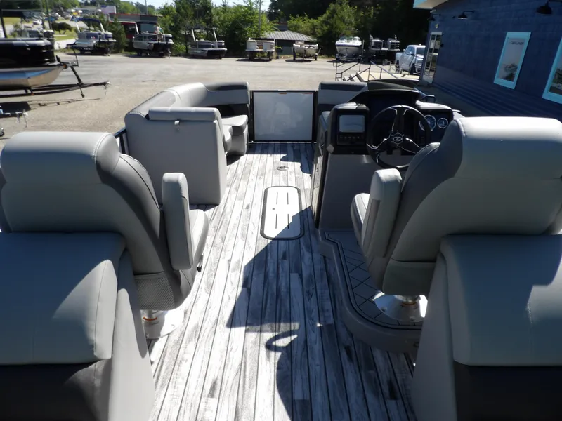 Slide: The Image of 2025 Veranda Relax 22 RC pontoon boat interior with luxurious seating and modern dashboard. - 15