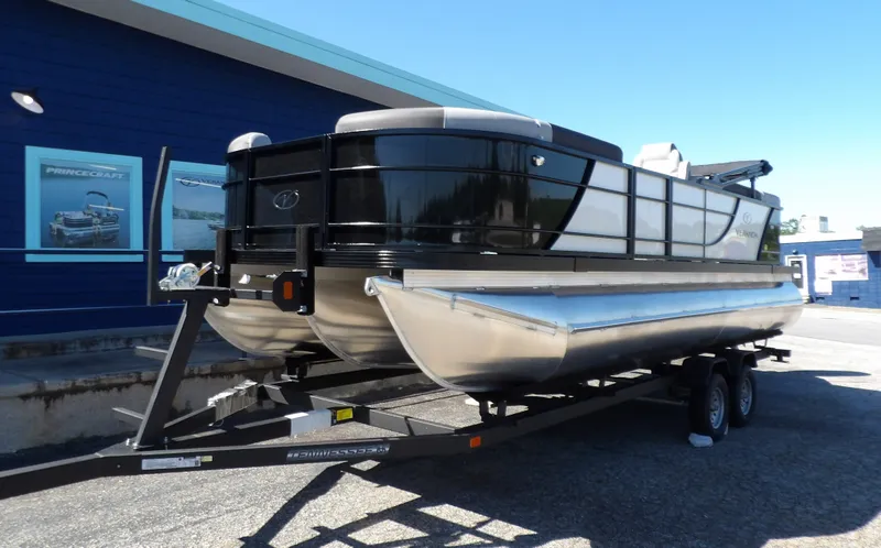 Slide: The Image of 2025 Veranda Relax 22 RC pontoon boat on trailer, parked outside dealership. - 4
