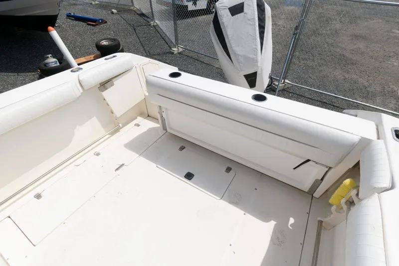 Slide: The Image of 2001 Boston Whaler 23 Conquest boat interior with white seating and storage compartments. - 7