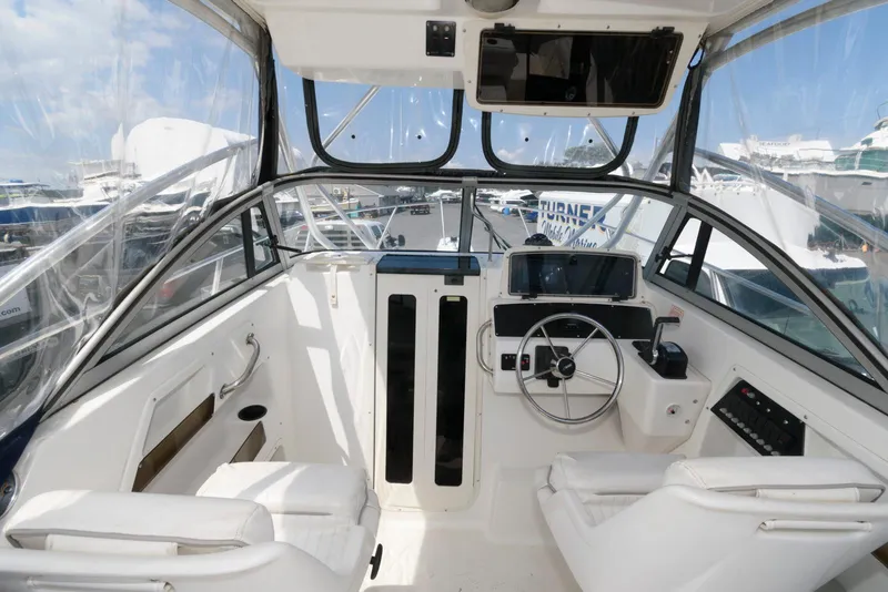 Slide: The Image of 2001 Boston Whaler 23 Conquest boat interior with steering wheel and seating. - 8