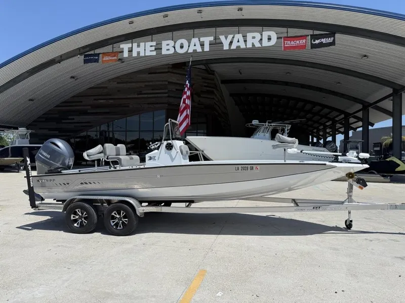 Slide: The Image of 2023 Xpress H22 Bay boat on trailer at The Boat Yard dealership. - 1