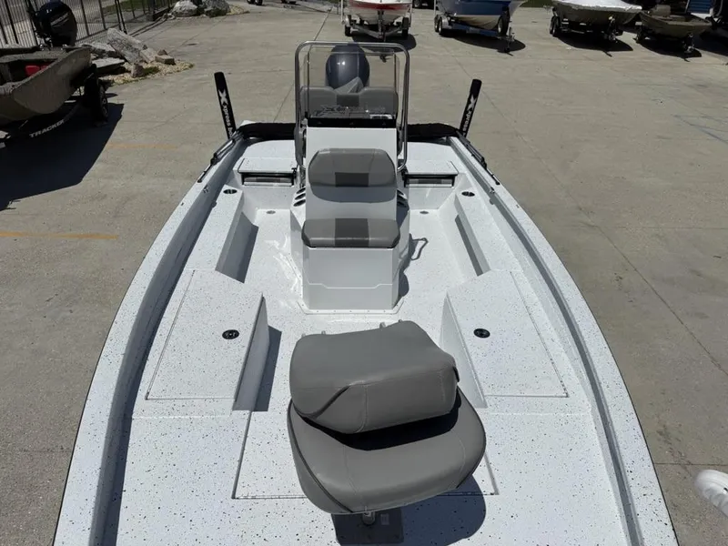 Slide: The Image of 2023 Xpress H22 Bay boat with gray seating, docked outdoors. - 12
