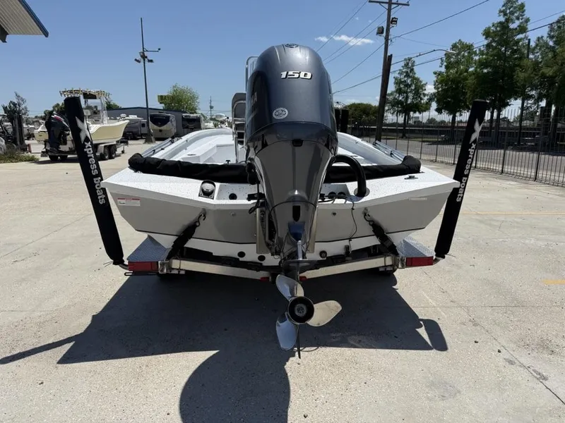 Slide: The Image of 2023 Xpress H22 Bay boat with Yamaha 150 engine, parked on a trailer. - 4