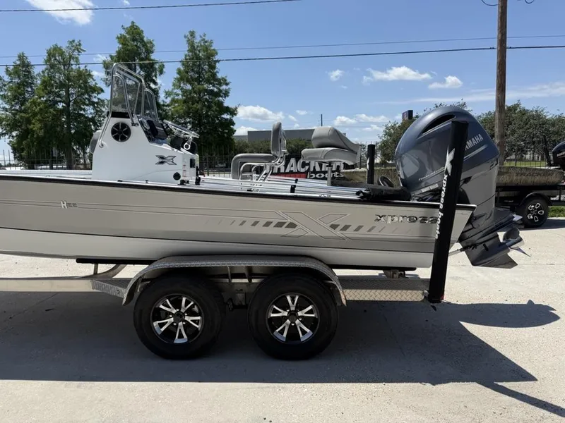 Slide: The Image of 2023 Xpress H22 Bay boat on trailer with Yamaha outboard motor. - 7