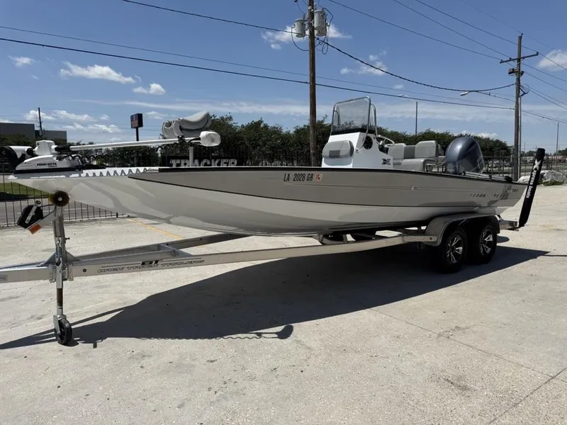 Slide: The Image of 2023 Xpress H22 Bay boat on trailer, parked outdoors under clear sky. - 8
