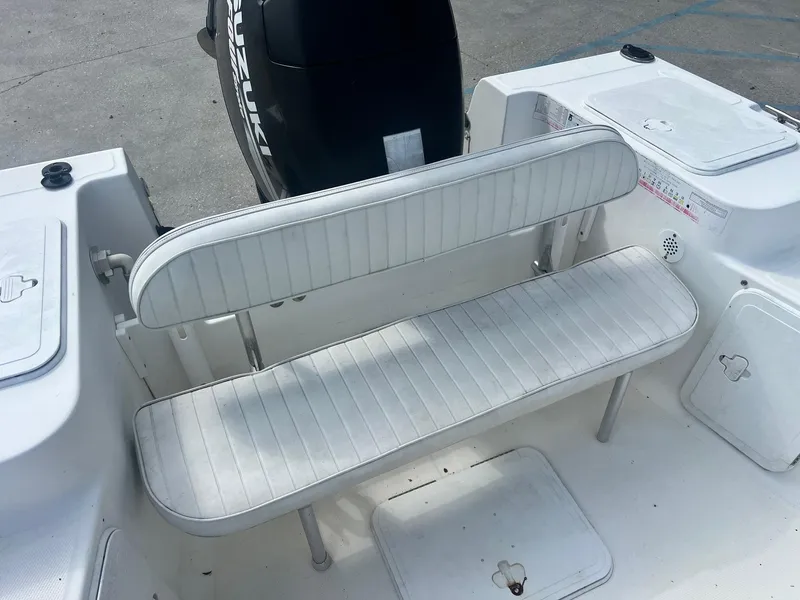 Slide: The Image of 2007 Sea Fox Pro Series Center Console 197 boat interior with white seating and Suzuki engine. - 6
