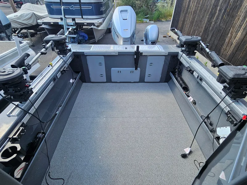 Slide: The Image of 2023 RH Boats 22 Coastal Hardtop interior, featuring spacious deck and fishing equipment. - 14