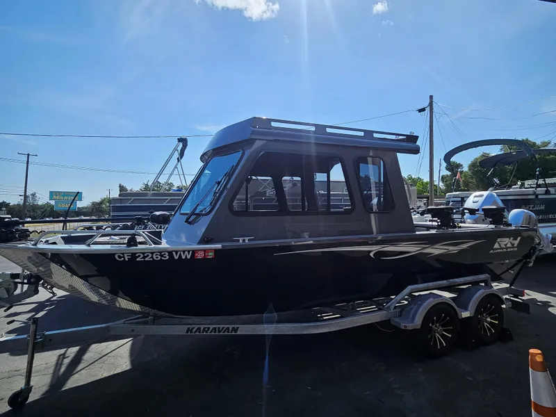 Slide: The Image of 2023 RH Boats 22 Coastal Hardtop on trailer under bright blue sky. - 18