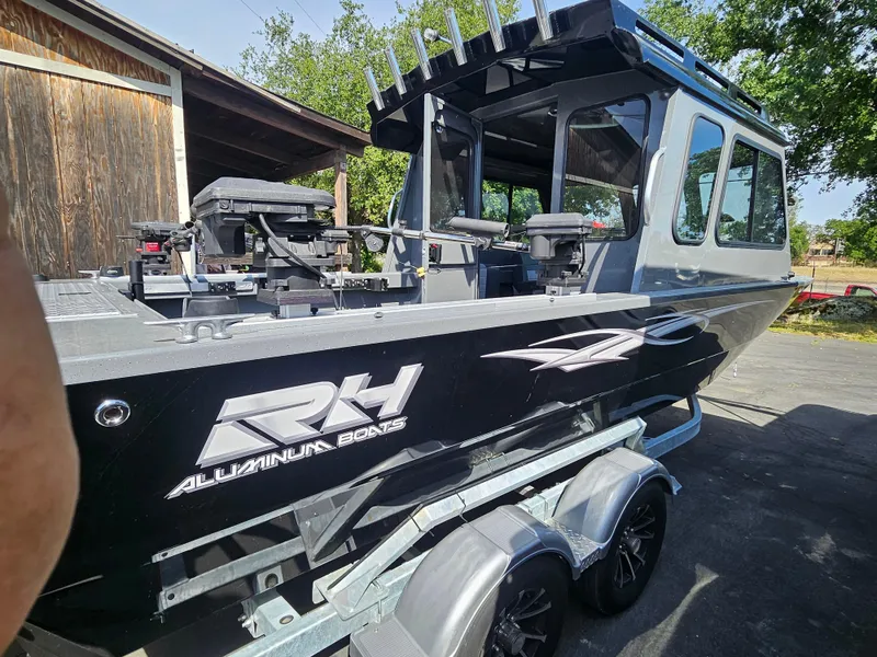 Slide: The Image of 2023 RH Boats 22 Coastal Hardtop on trailer, featuring sleek aluminum design. - 21