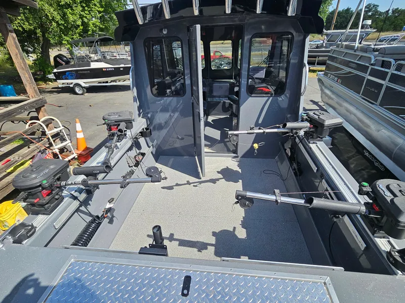 Slide: The Image of 2023 RH Boats 22 Coastal Hardtop interior with fishing rod holders and spacious deck. - 22