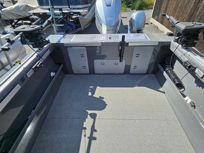 Slide: The Image of 2023 RH Boats 22 Coastal Hardtop interior with spacious deck and fishing equipment. - 26