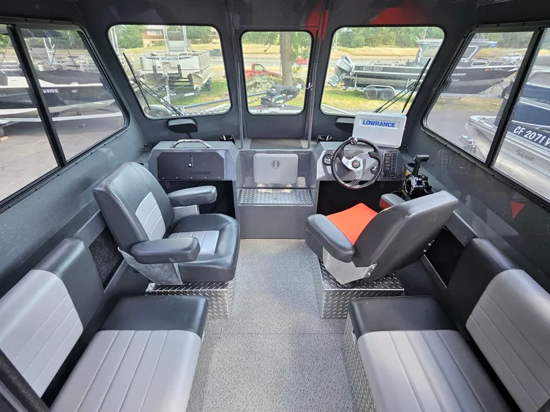 Slide: The Image of Interior of 2023 RH Boats 22 Coastal Hardtop, featuring seating and navigation equipment. - 34