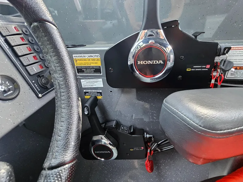 Slide: The Image of 2023 RH Boats 22 Coastal Hardtop dashboard with Honda controls and steering wheel. - 35