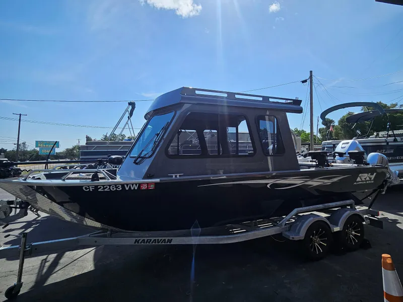 Slide: The Image of 2023 RH Boats 22 Coastal Hardtop on trailer under sunny sky. - 4