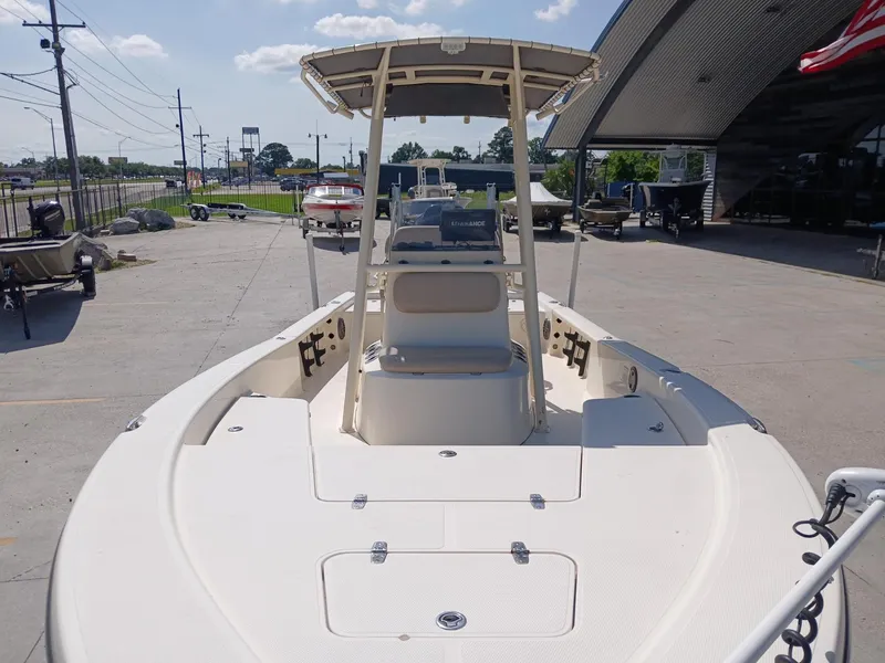 Slide: The Image of 2013 BlackJack 224 boat on display at a dealership, sunny day. - 13