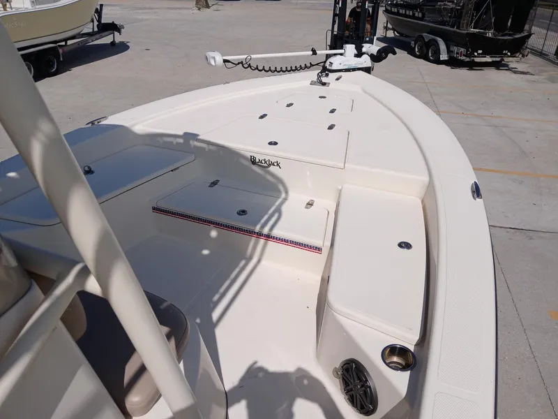 Slide: The Image of 2013 BlackJack 224 boat interior with seating and storage compartments. - 15