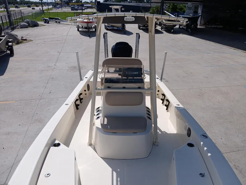 Slide: The Image of 2013 BlackJack 224 boat interior with console and seating, parked outdoors. - 16