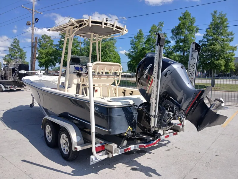 Slide: The Image of 2013 BlackJack 224 boat on trailer with Yamaha outboard motor, parked outdoors. - 3