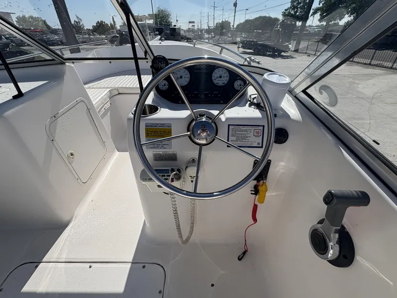 Slide: The Image of 2007 Sea Hunt Escape 200 boat cockpit with steering wheel and control panel. - 6