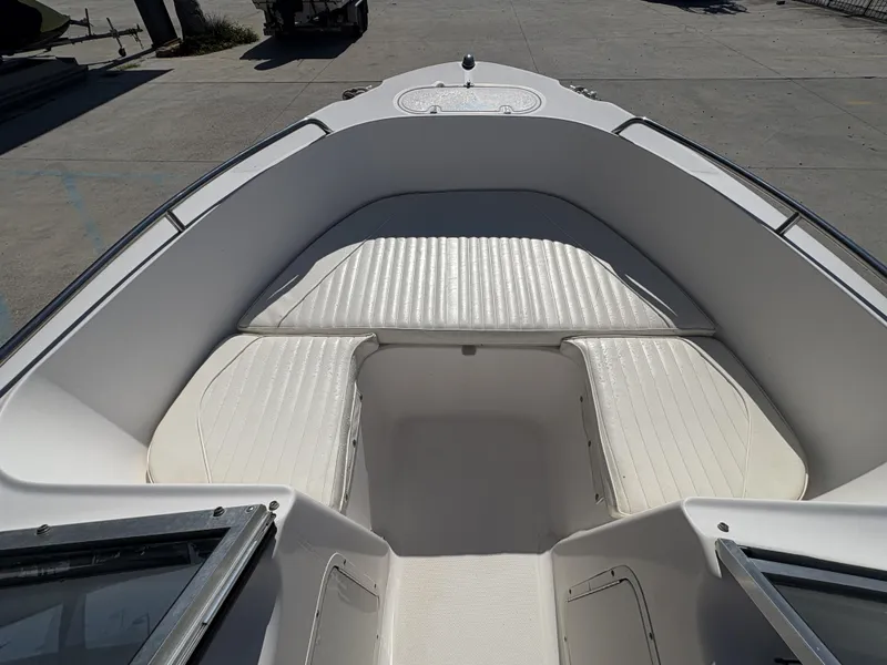 Slide: The Image of 2007 Sea Hunt Escape 200 boat interior with white cushioned seating. - 7