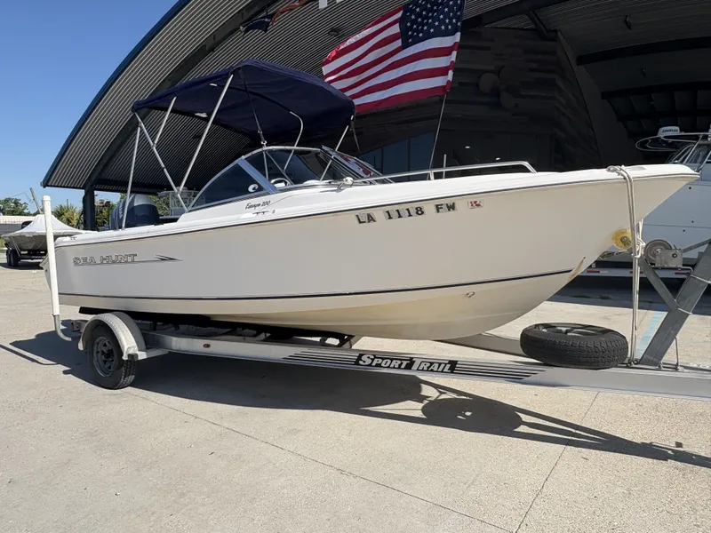 Slide: The Image of 2007 Sea Hunt Escape 200 boat on trailer with American flag in background. - 9