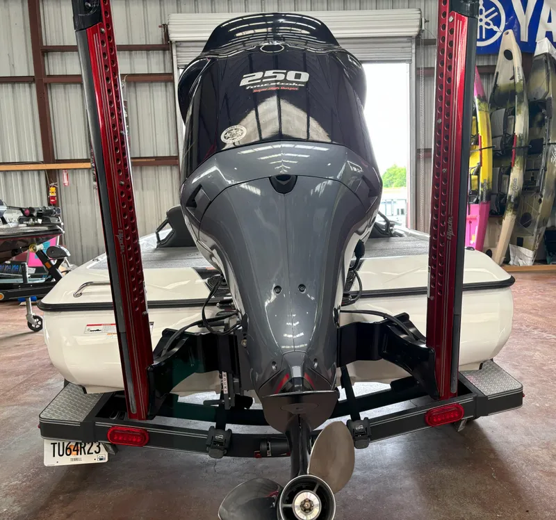 Slide: The Image of 2021 Skeeter ZXR21 boat with powerful 250 horsepower engine in a garage setting. - 11