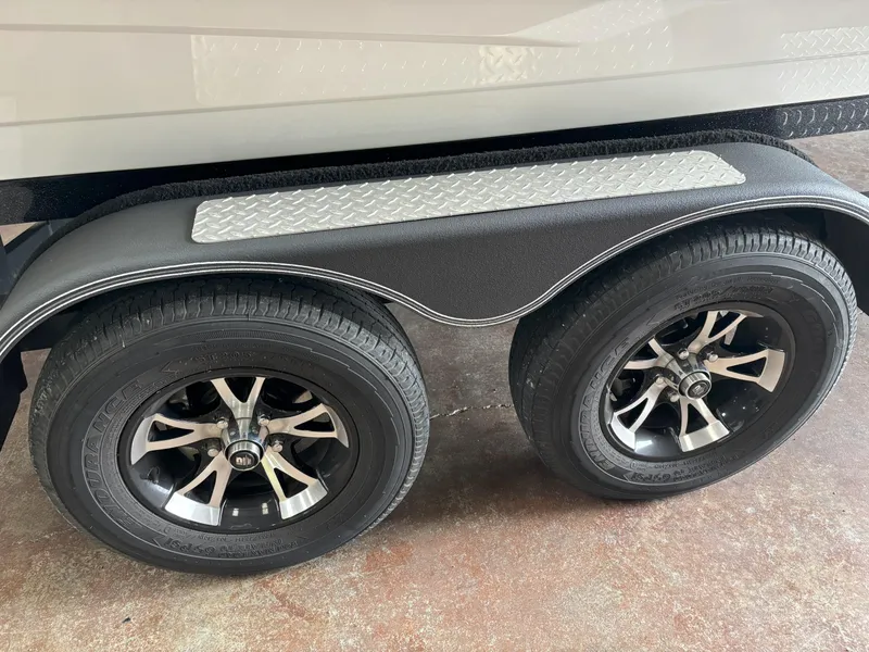 Slide: The Image of Dual wheels on a 2021 Skeeter ZXR21 trailer with black and silver rims. - 13