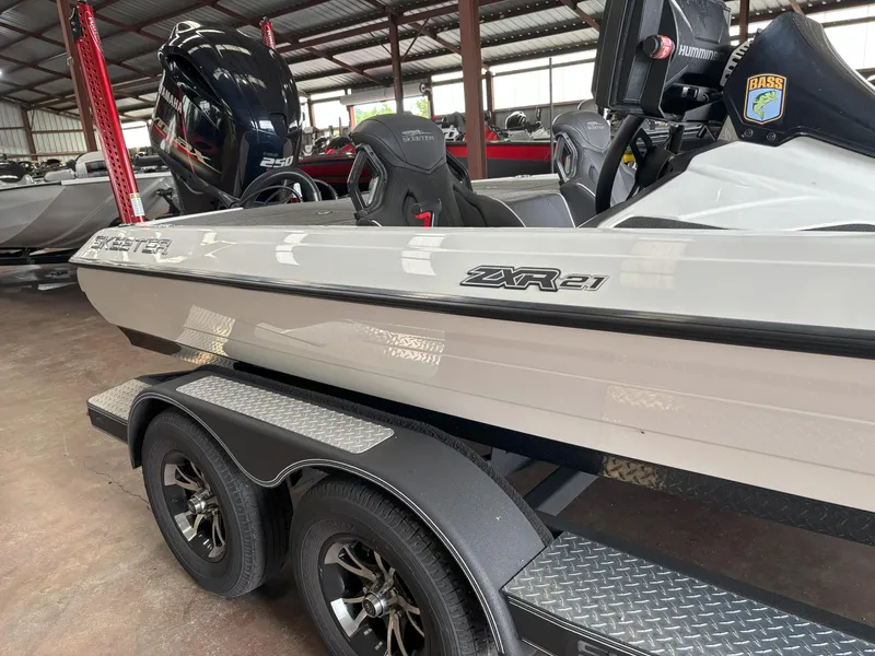 Slide: The Image of 2021 Skeeter ZXR21 boat on trailer in a warehouse setting. - 17