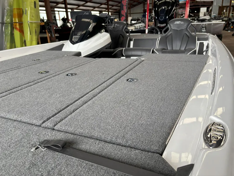 Slide: The Image of 2021 Skeeter ZXR21 boat interior with gray carpeted deck and sleek seating. - 21