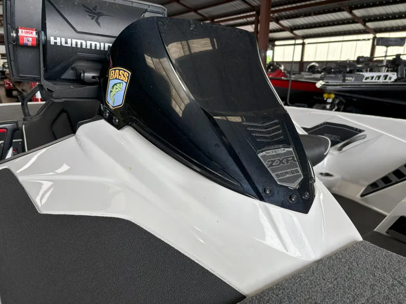 Slide: The Image of 2021 Skeeter ZXR21 boat with Humminbird electronics and Bass logo in a covered storage area. - 3