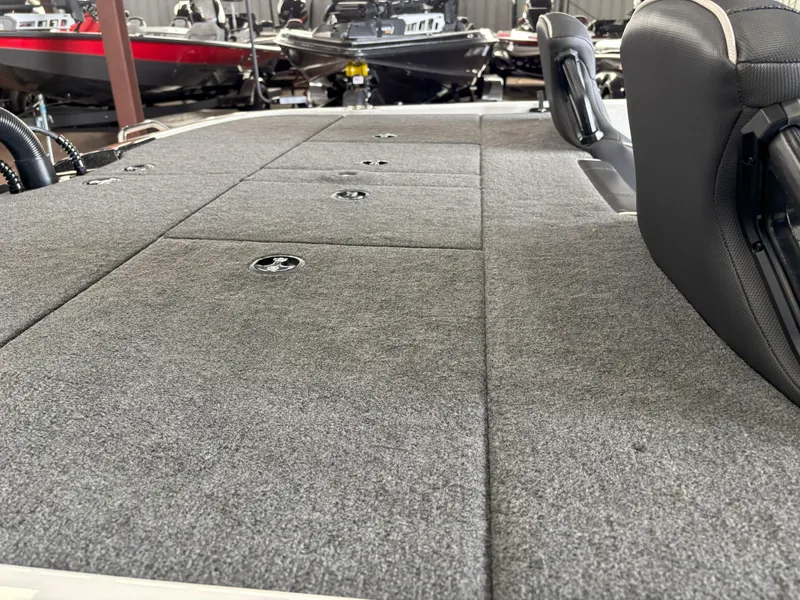 Slide: The Image of 2021 Skeeter ZXR21 boat interior with gray carpeted deck and seating. - 9