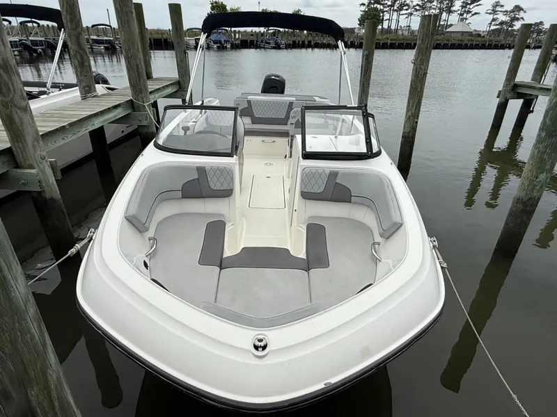 Slide: The Image of 2023 Bayliner VR6 Bowrider OB docked, showcasing spacious seating and sleek design. - 1