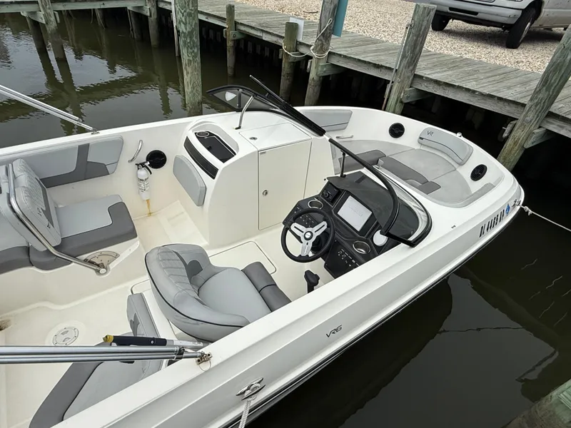 Slide: The Image of 2023 Bayliner VR6 Bowrider OB, sleek design, spacious seating, docked at marina. - 3