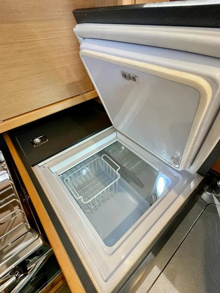 Slide: The Image of Built-in refrigerator in 2021 Jeanneau Sun Odyssey 319 yacht kitchen. - 10