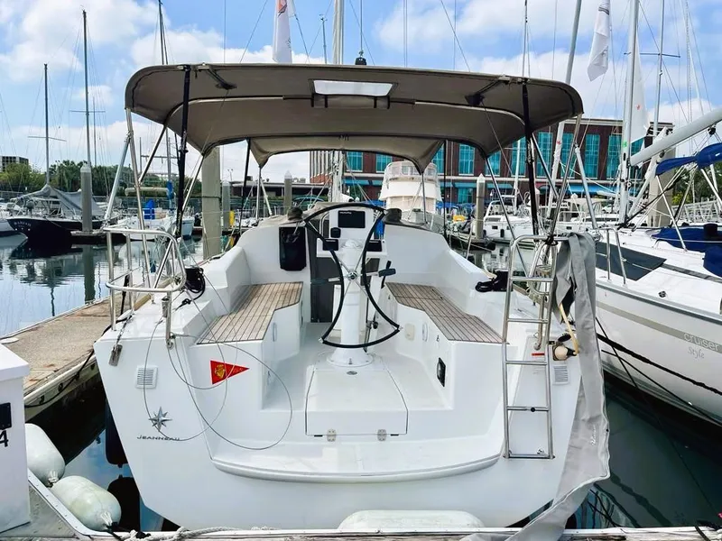 Slide: The Image of 2021 Jeanneau Sun Odyssey 319 sailboat docked at marina, rear view. - 3