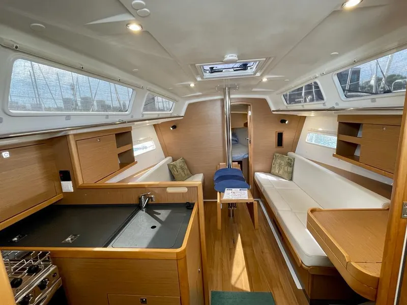 Slide: The Image of Interior of 2021 Jeanneau Sun Odyssey 319 sailboat, featuring modern wood finish and cozy seating. - 5