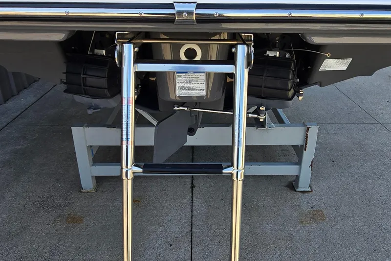 Slide: The Image of Rear view of 2020 Yamaha Boats AR240 with ladder and dual engines on display stand. - 14