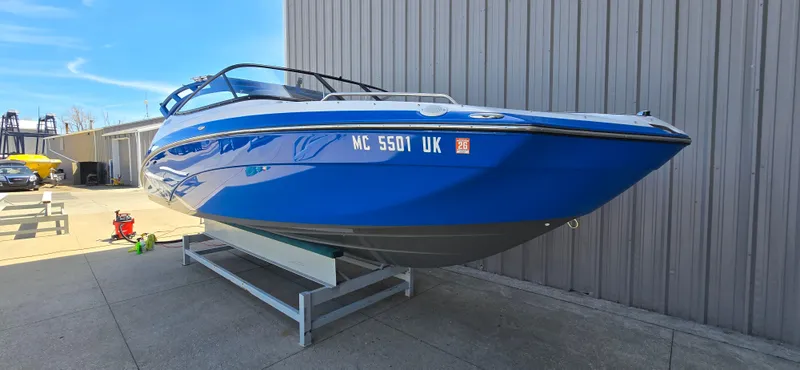 Slide: The Image of 2020 Yamaha Boats AR240 in blue, displayed on a stand outdoors. - 3