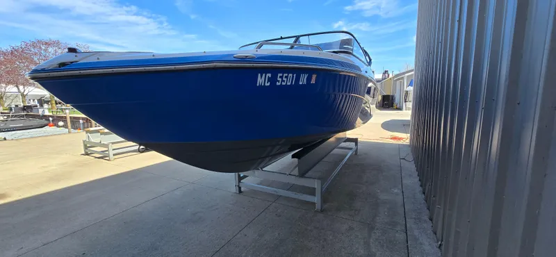 Slide: The Image of 2020 Yamaha Boats AR240 in blue, docked on a stand, sunny day. - 4