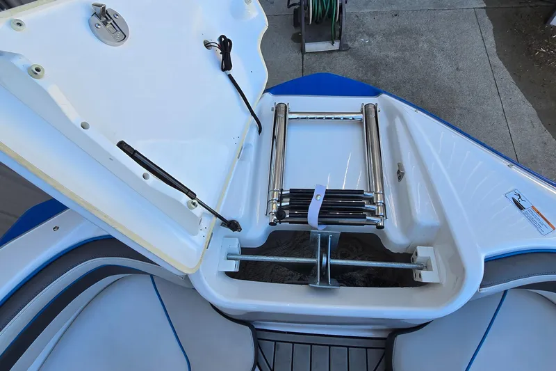 Slide: The Image of 2020 Yamaha AR240 boat with open storage compartment and retractable ladder. - 7