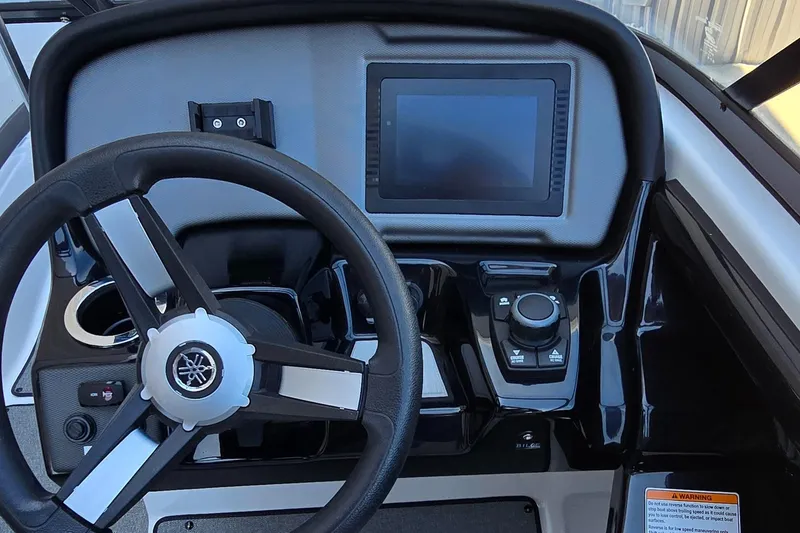 Slide: The Image of 2020 Yamaha AR240 boat dashboard with steering wheel and digital display. - 9