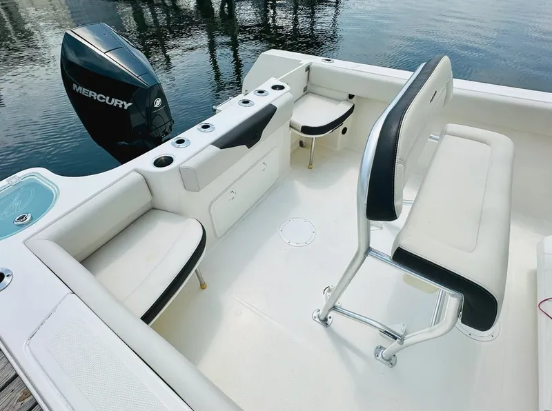 Slide: The Image of 2022 Sailfish 242 CC boat interior with seating and Mercury outboard engine. - 15